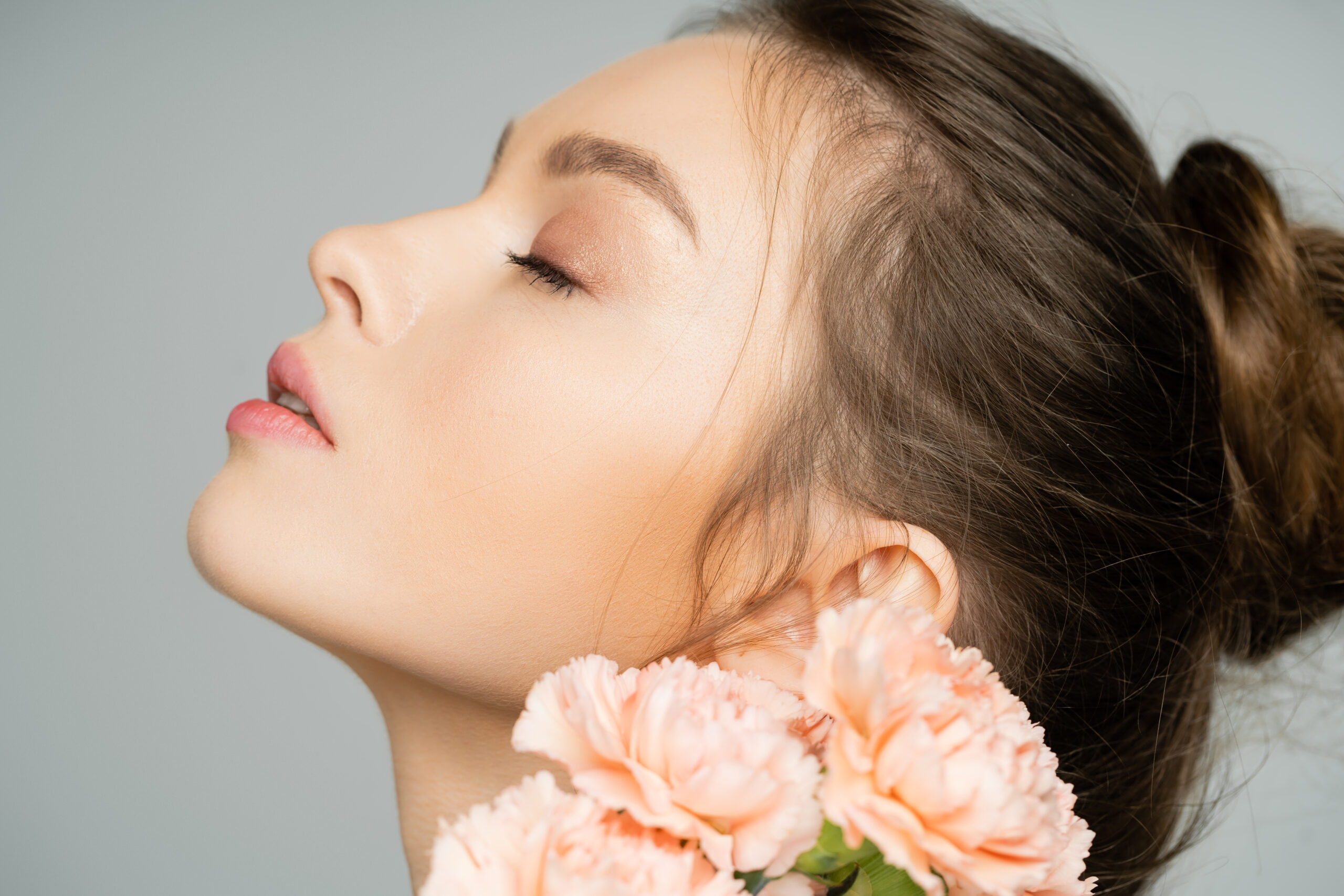 closed eyes of a woman with pink flowers