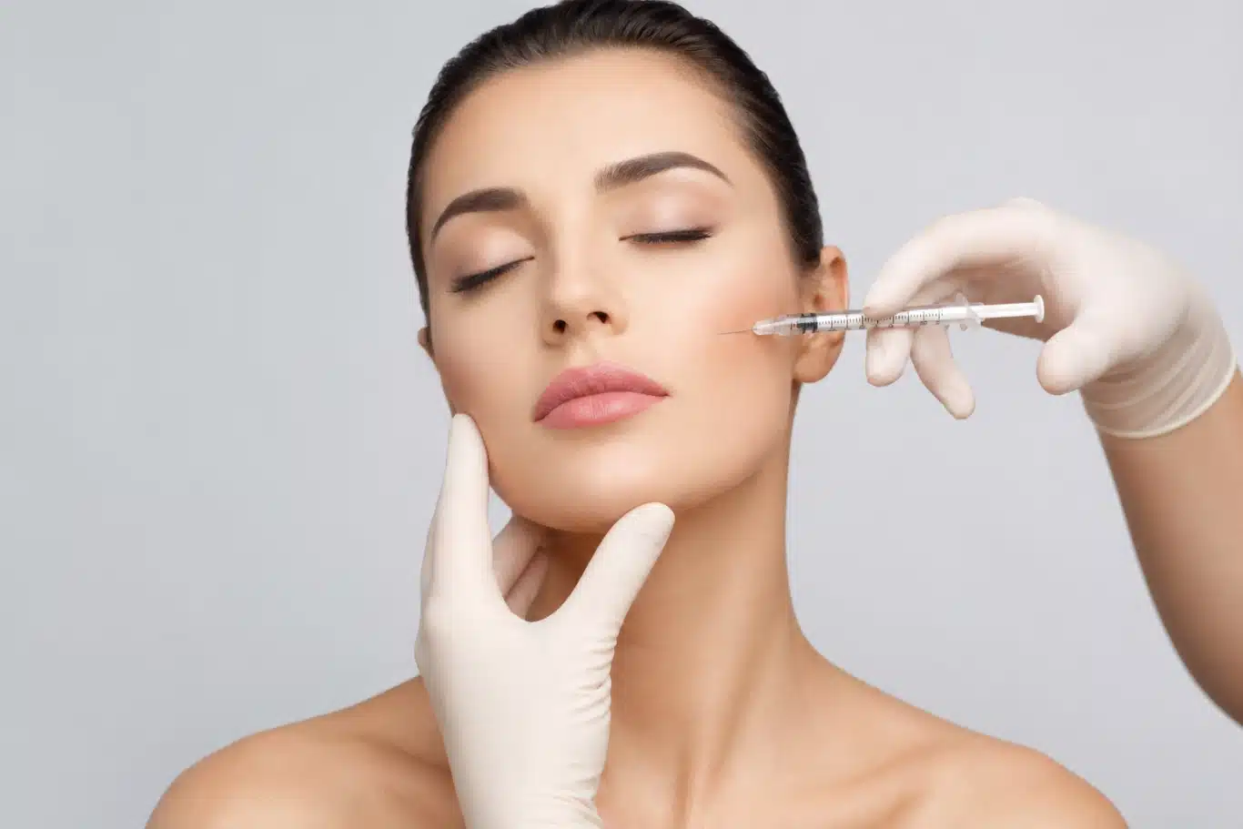 Facial filler injection in womans cheek for smoothing wrinkles